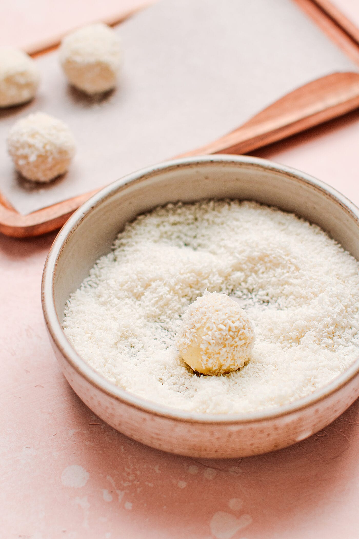 White chocolate truffle coated with shredded coconut.