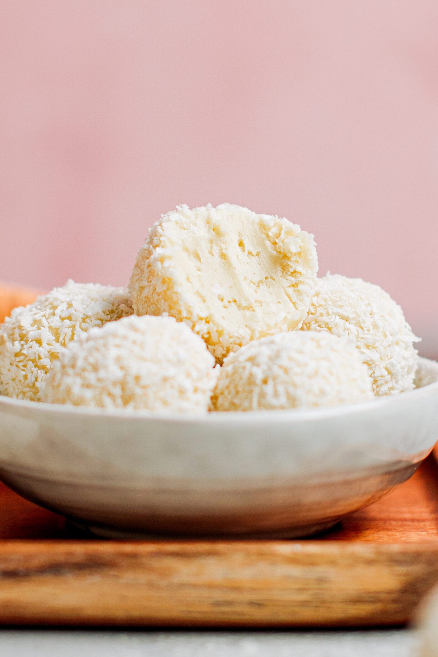 Vegan white chocolate truffles coated with shredded coconut.