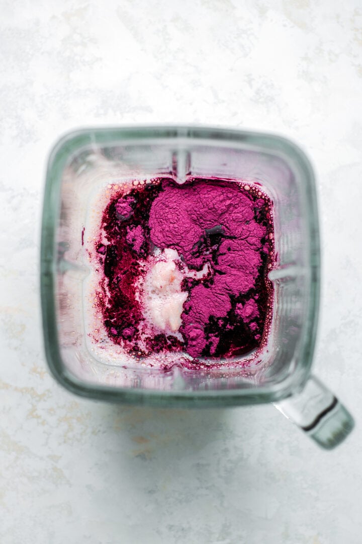 Mashed taro, sweet potato powder, milk, and tea in a blender.