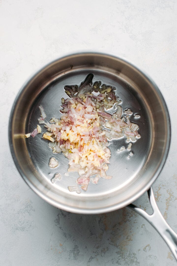 Sautéed garlic and shallots in a saucepan.