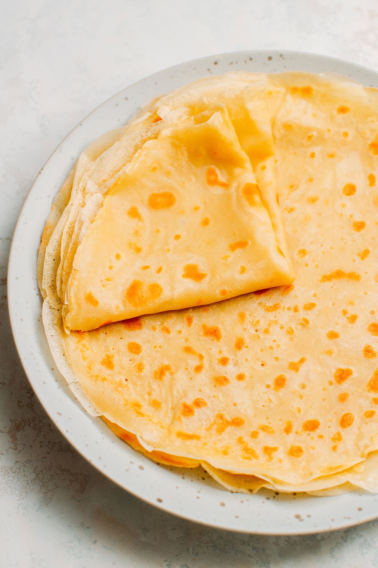 Folded crêpes on a plate.