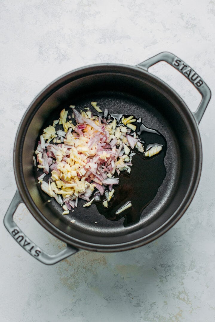 Minced shallots and garlic in a Dutch oven.