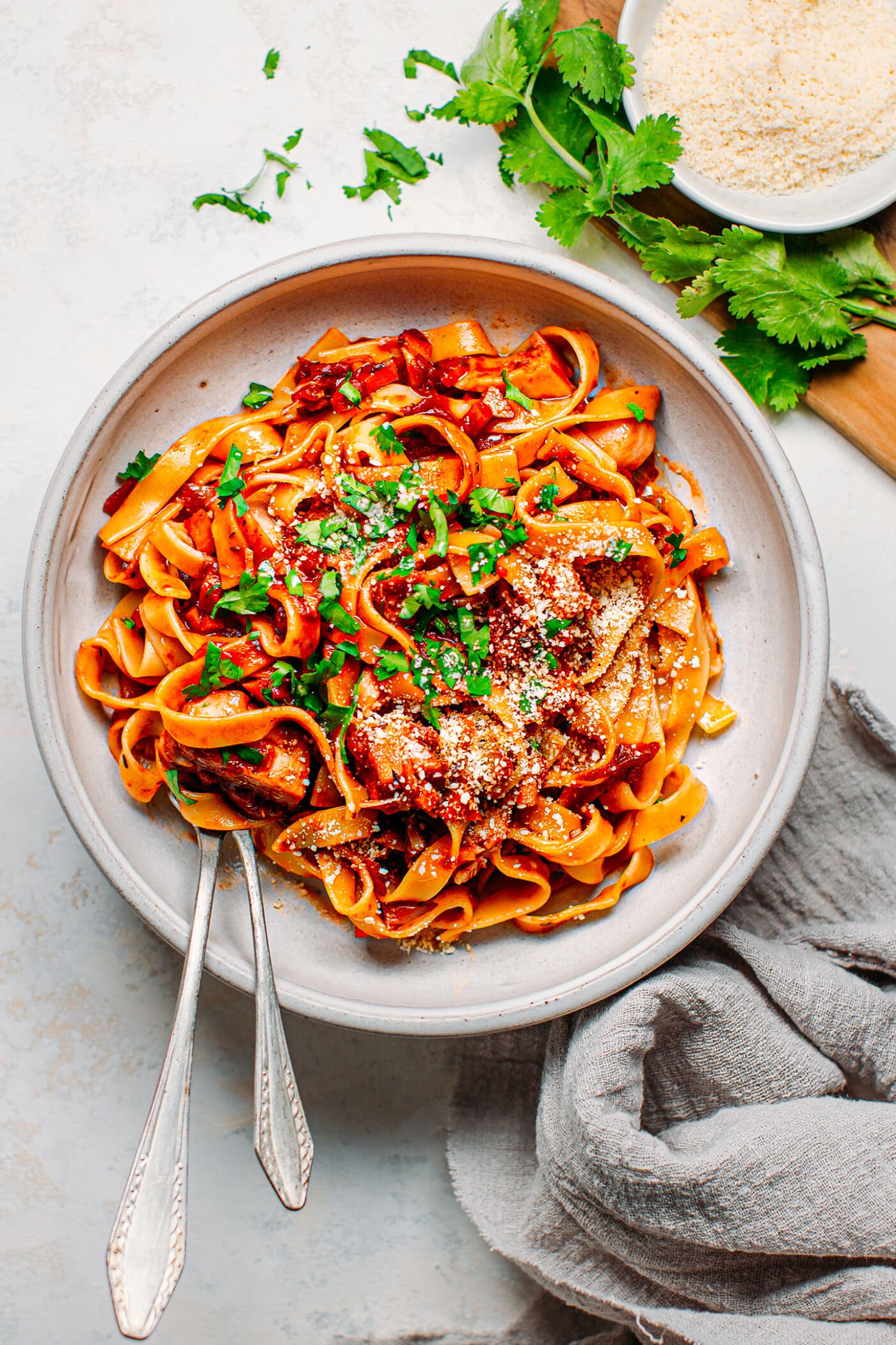 Vegan ragu pasta in a bowl with parsley and parmesan.