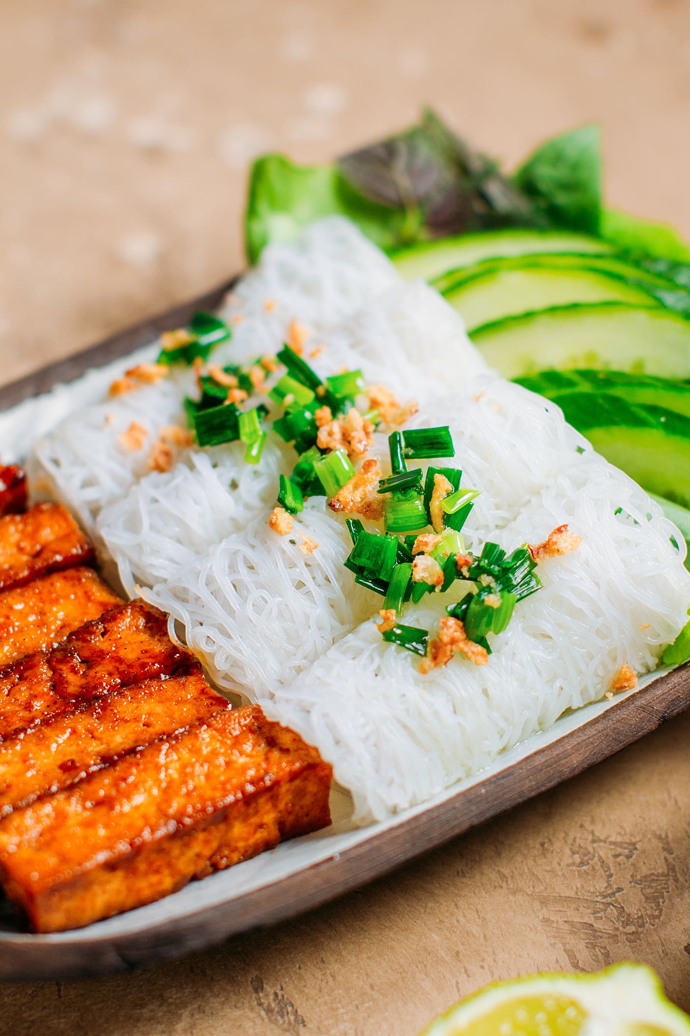 Close up of rice vermicelli woven topped with green onions.