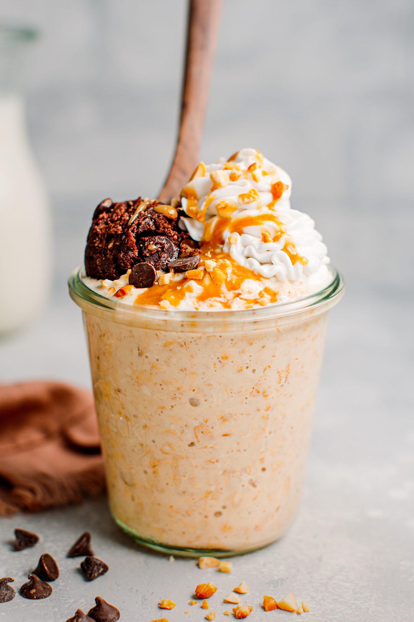 Overnight oats topped with cookie dough, coconut cream, and caramel sauce.