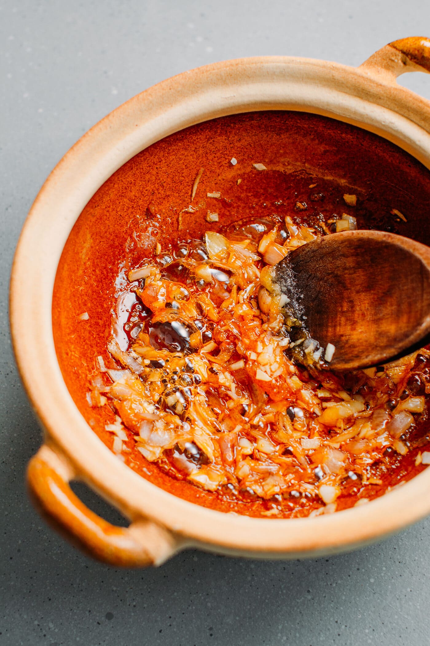 Sautéed shallots and garlic in a clay pot.