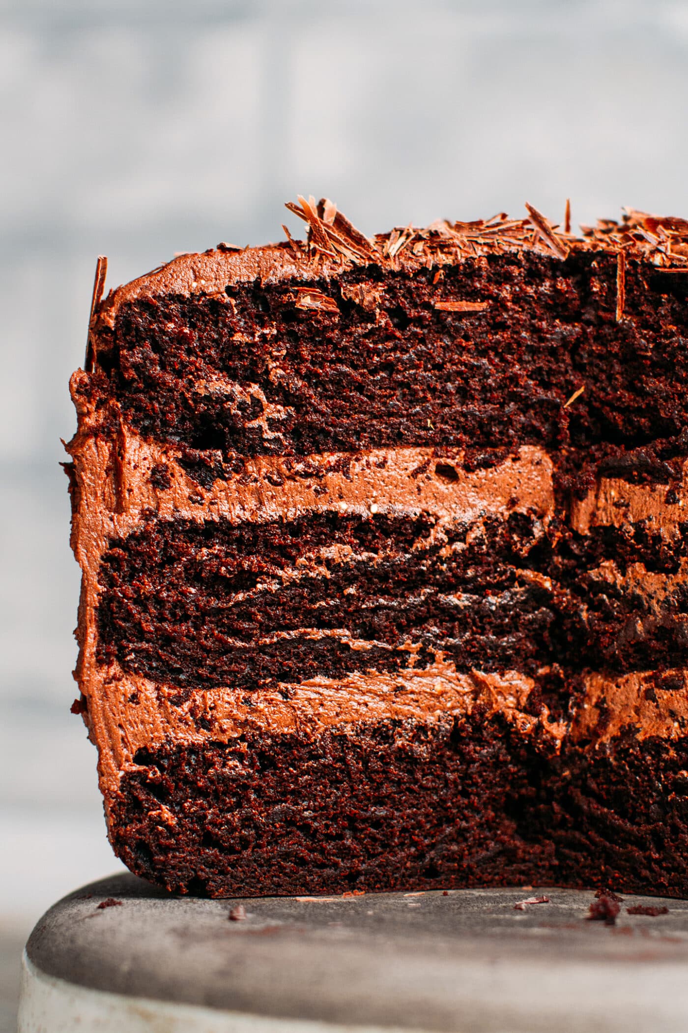 Close up of vegan chocolate cake with layers of buttercream.