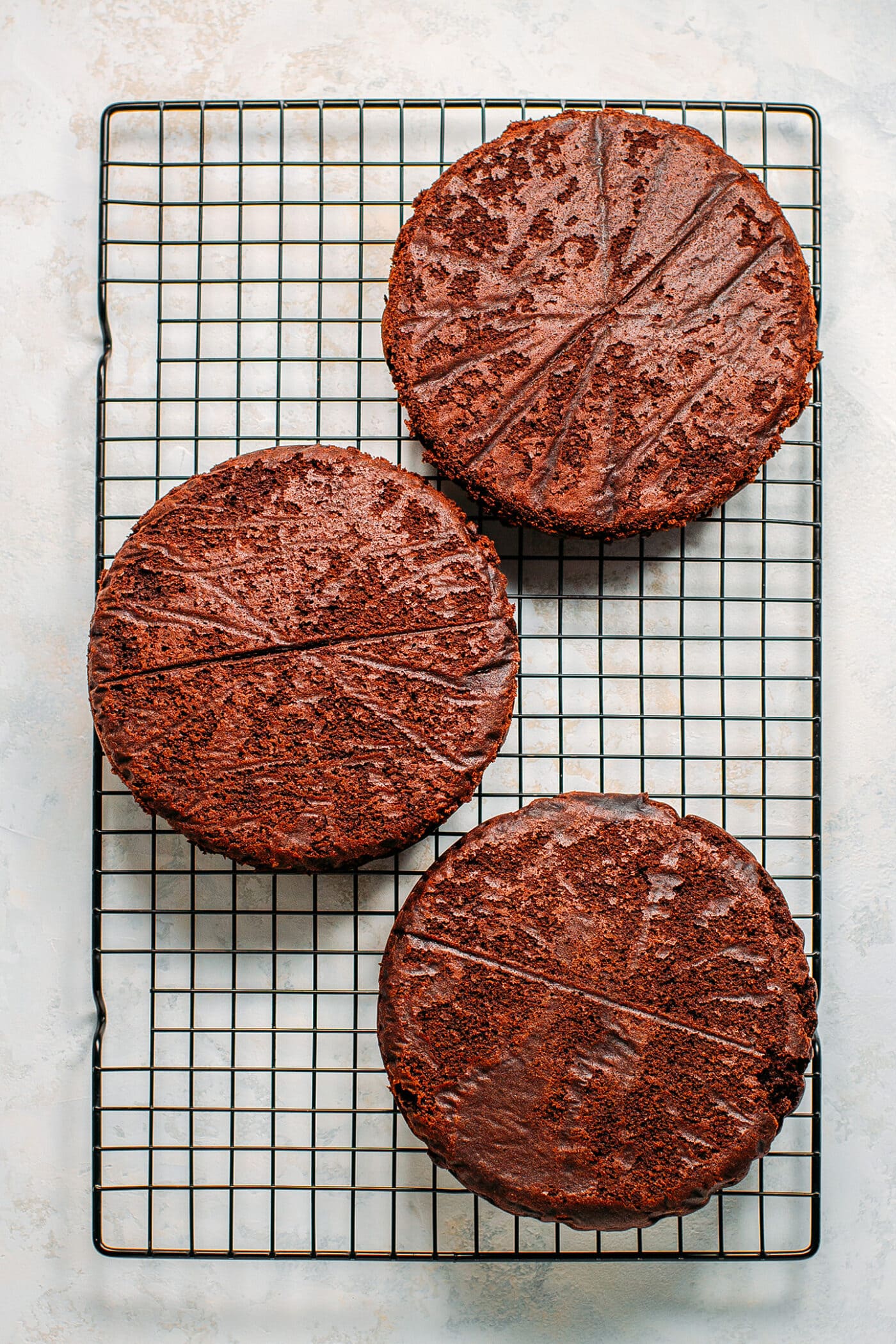 Vegan chocolate cakes cooling on a rack.