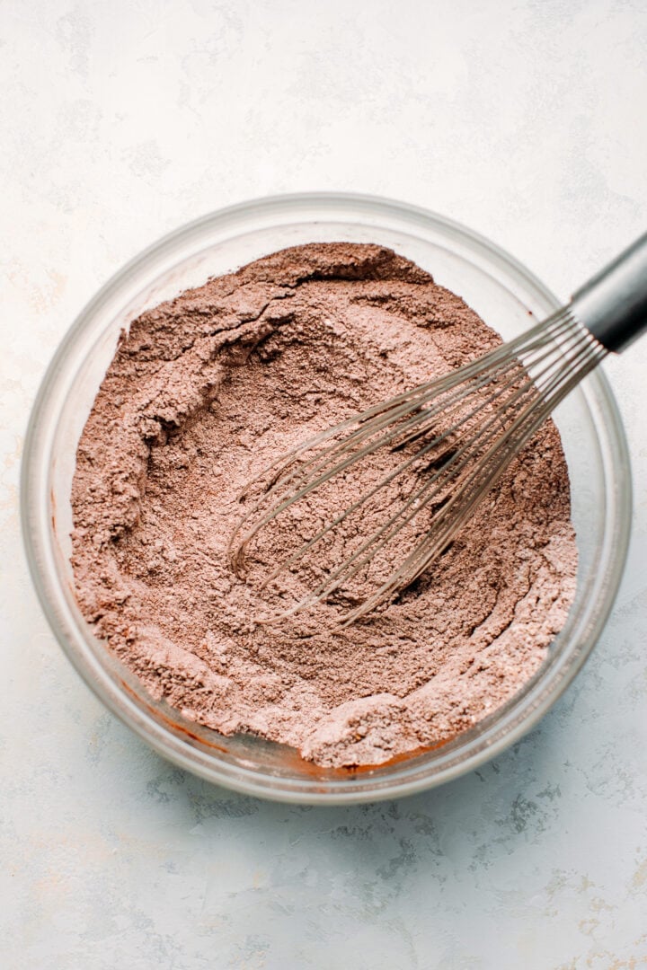 Whisking together the dry ingredients to make chocolate cake.