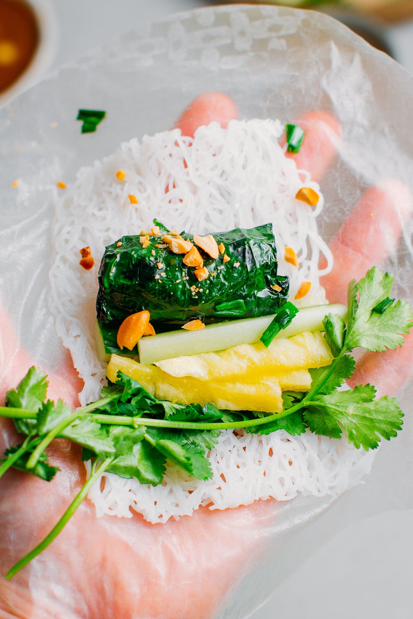 Grilled betel leaves with cucumber, cilantro, rice noodles, and pineapple.