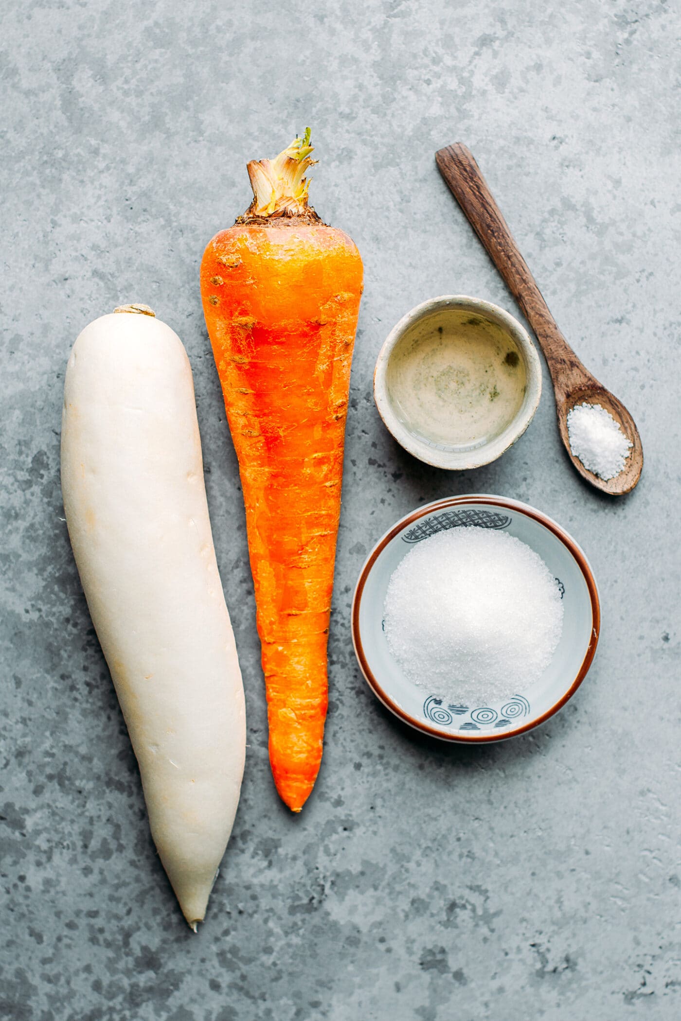 Ingredients like daikon radish, carrot, vinegar, salt, and sugar.