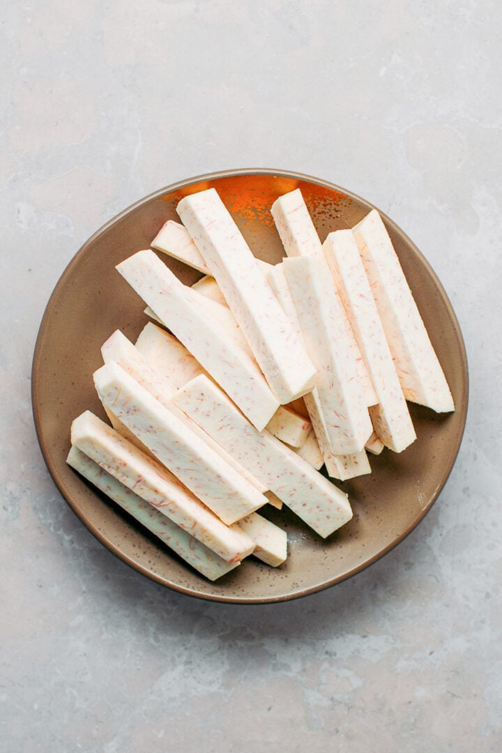 Taro cut into strips on a plate.