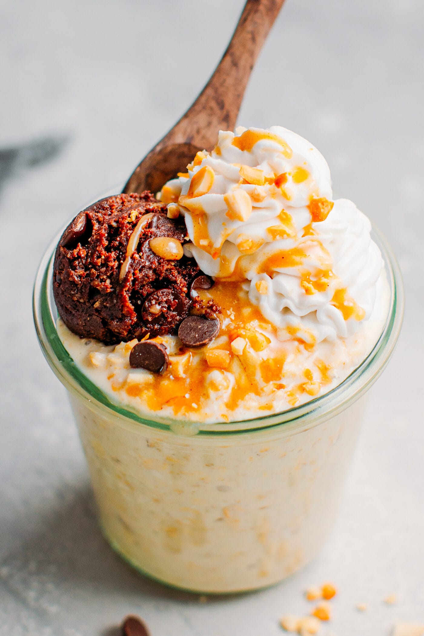 Overnight oats topped with cookie dough, coconut cream, and caramel sauce.