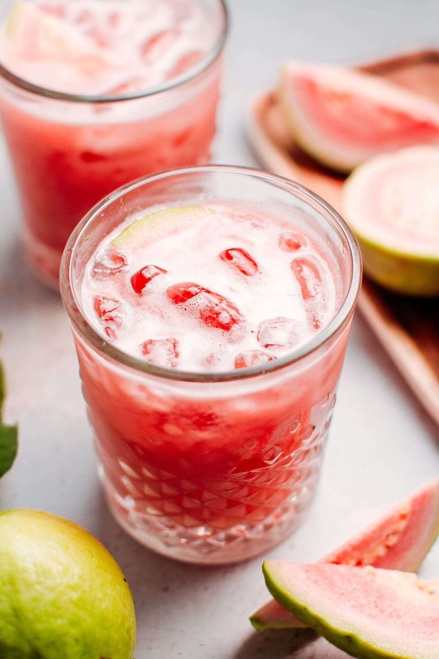 Guava jasmine iced tea in a glass with ice.