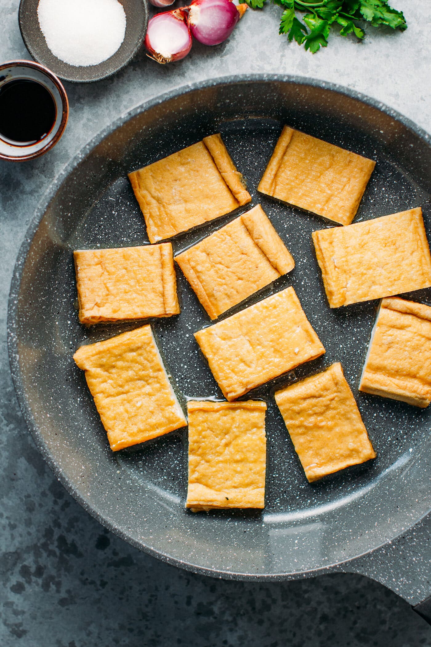 Fried tofu in a skillet.