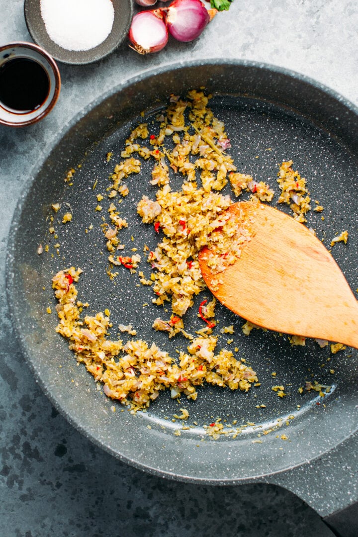 Sautéed lemongrass, garlic, shallots, and chili in a skillet.