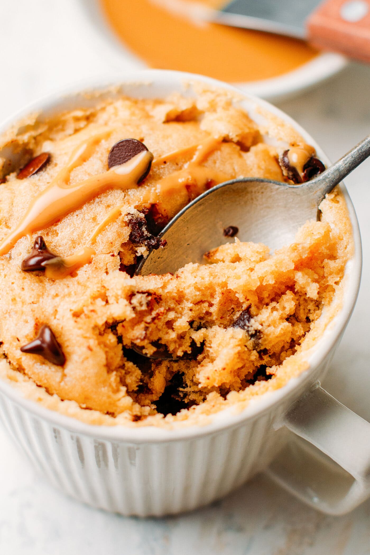 Close-up of vegan peanut butter mug cake with chocolate chips.