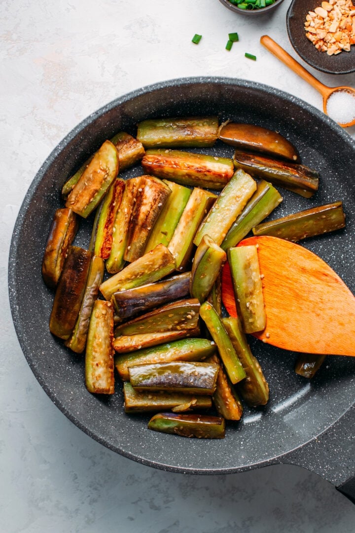 Sautéed eggplants in a skillet.