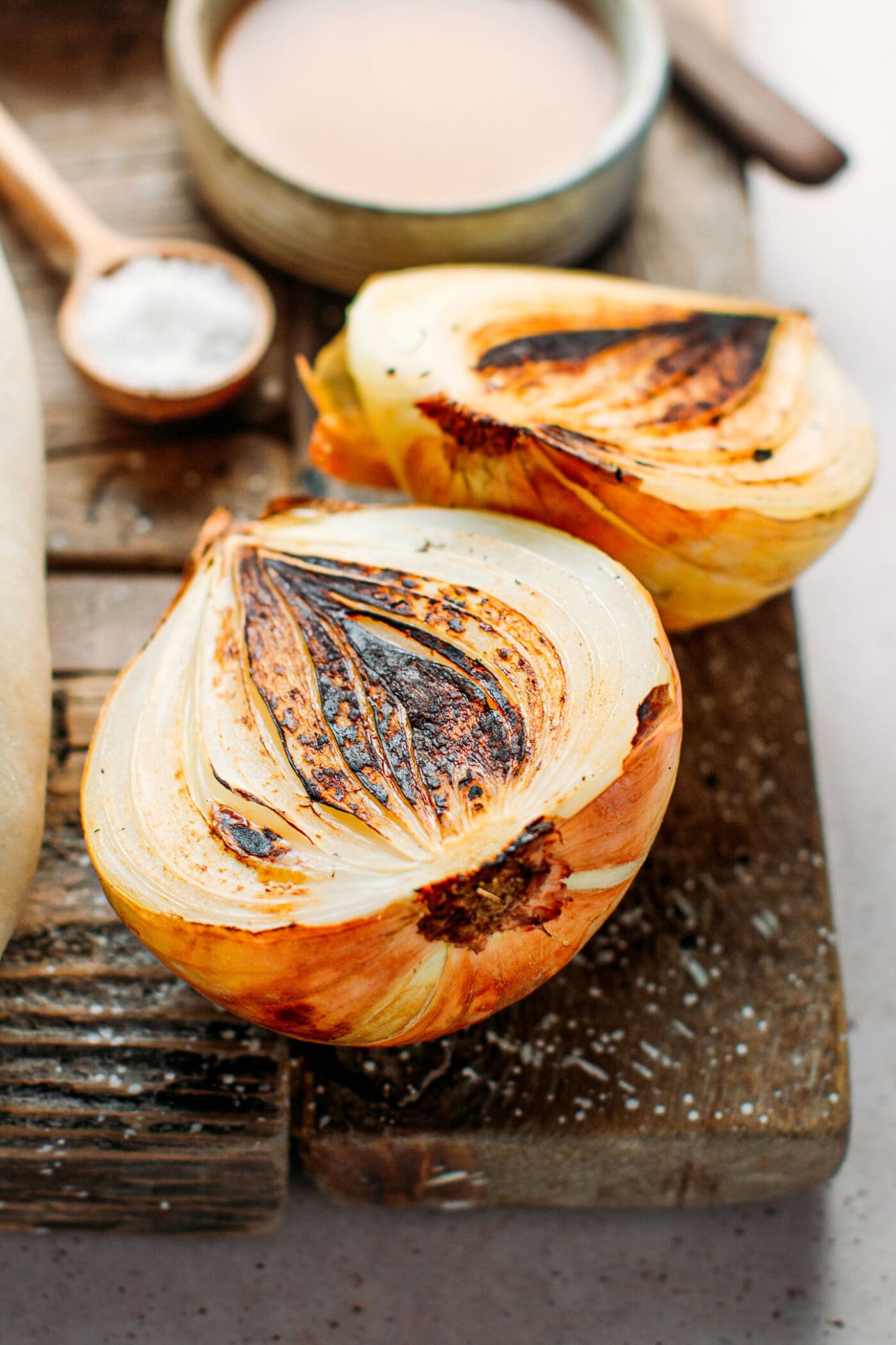 Charred onions on a cutting board.