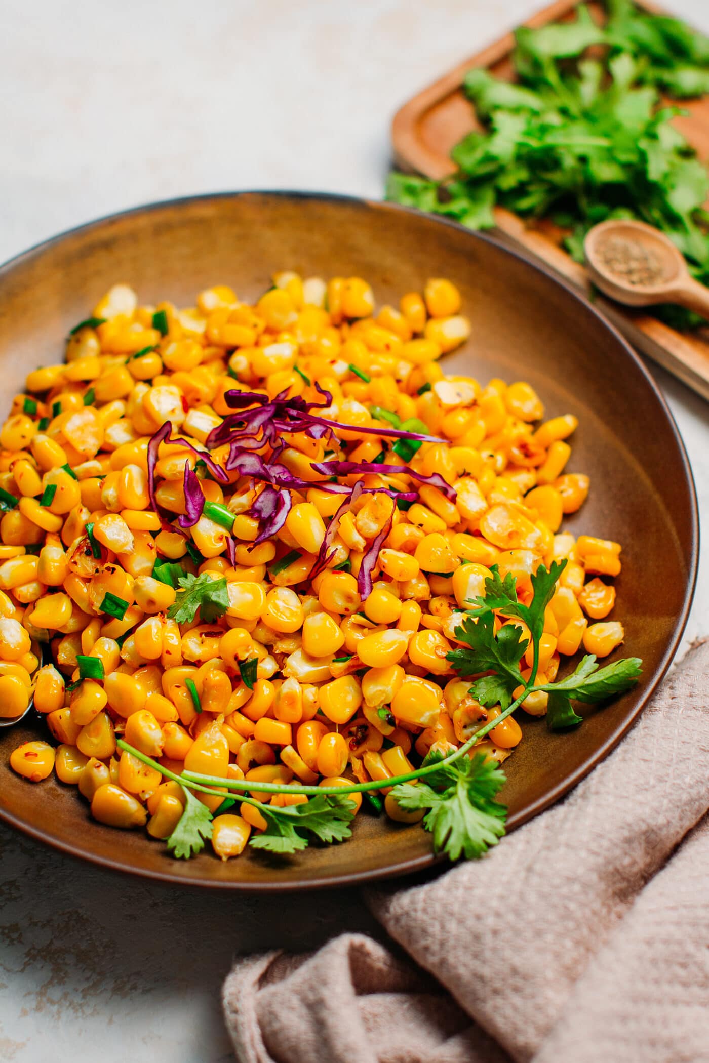 Close-up of buttered corn with scallions.