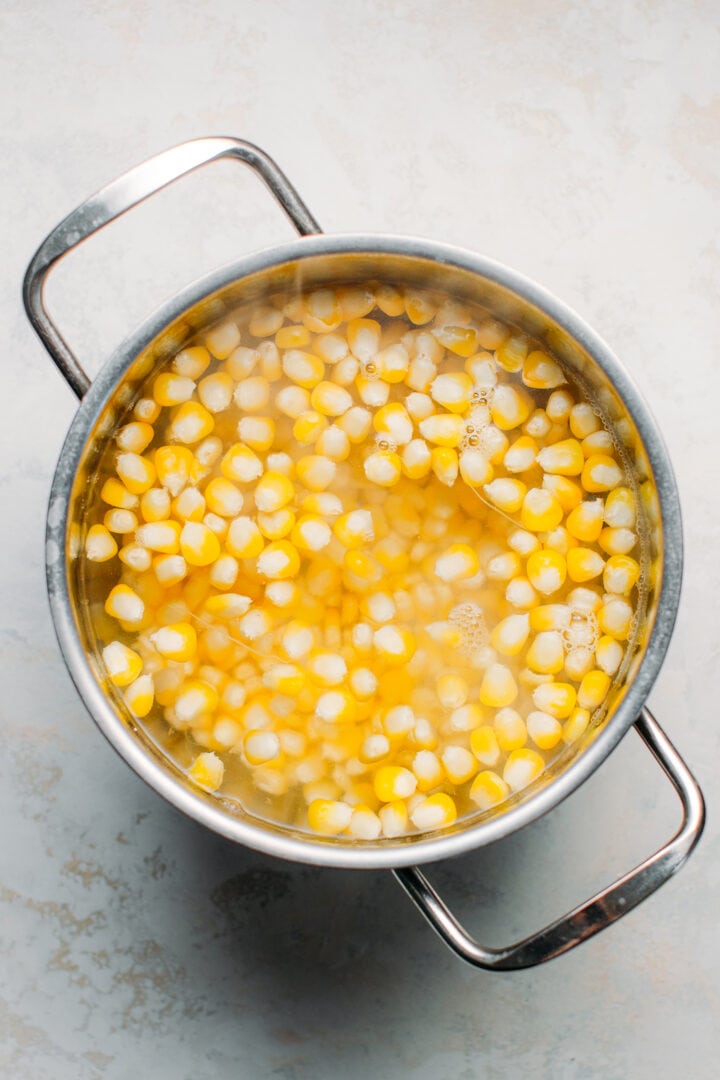 Boiling corn in a saucepan.