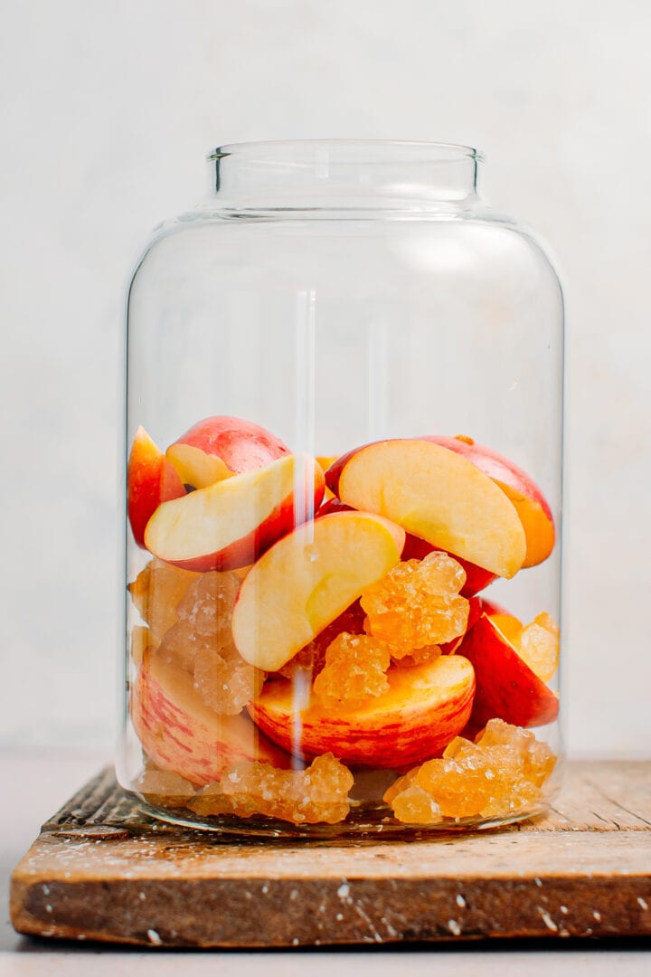 Sliced apples and rock sugar in a jar.