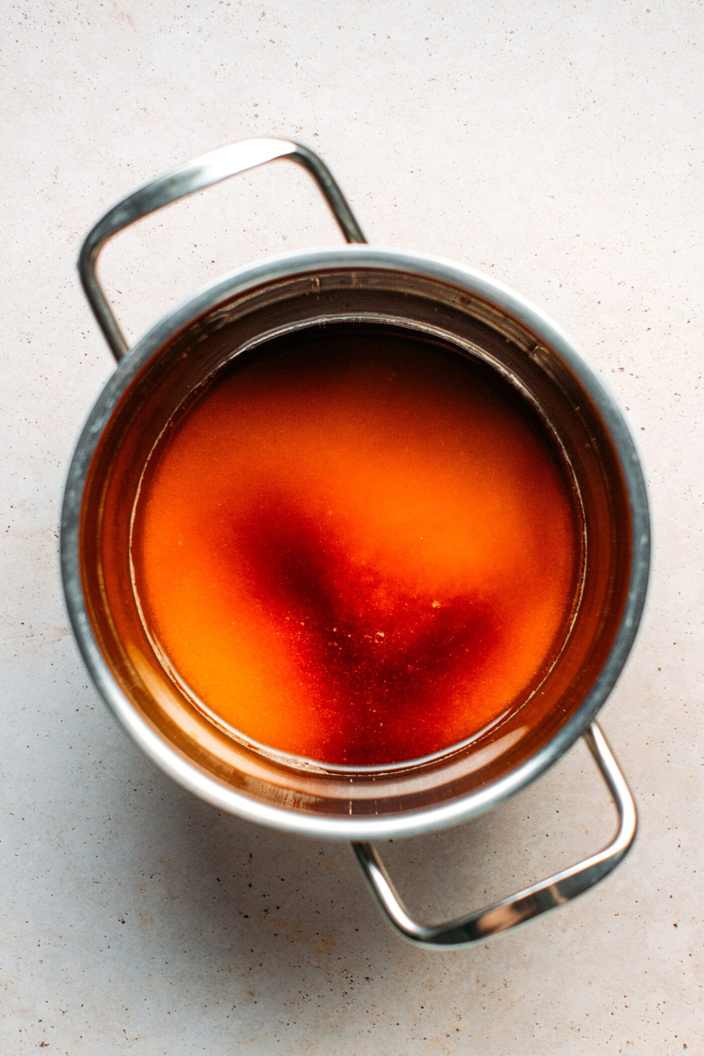 Sugar syrup in a saucepan.