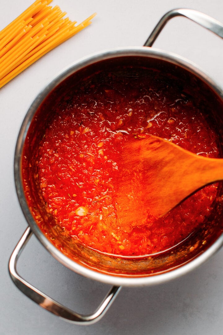 Cooking arrabbiata sauce in a saucepan.