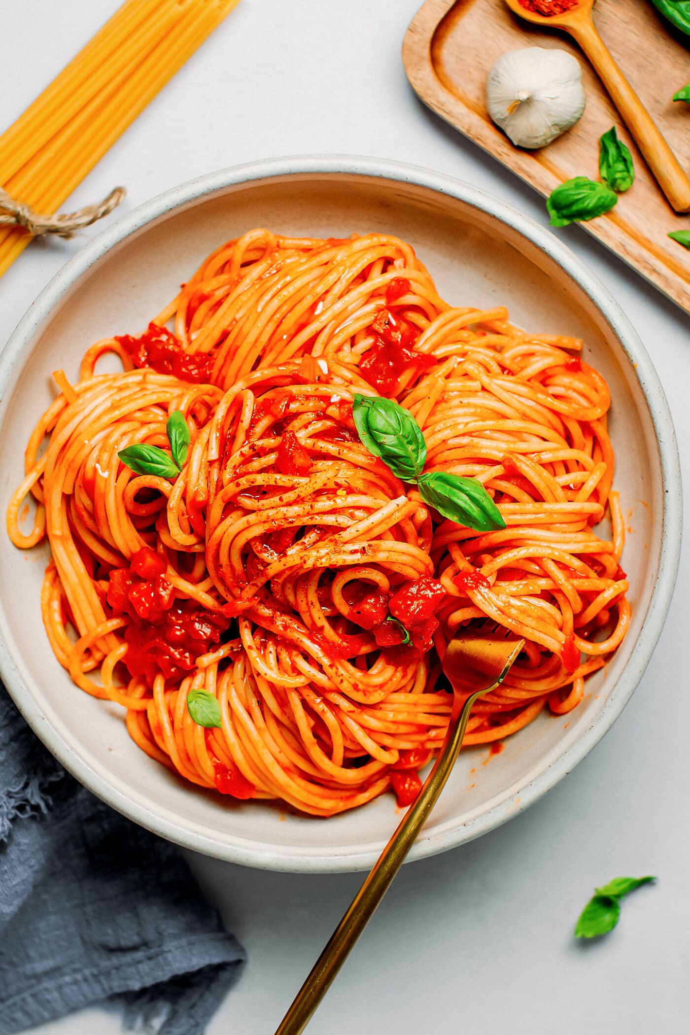 Close-up of spaghetti arrabbiata with fresh basil.