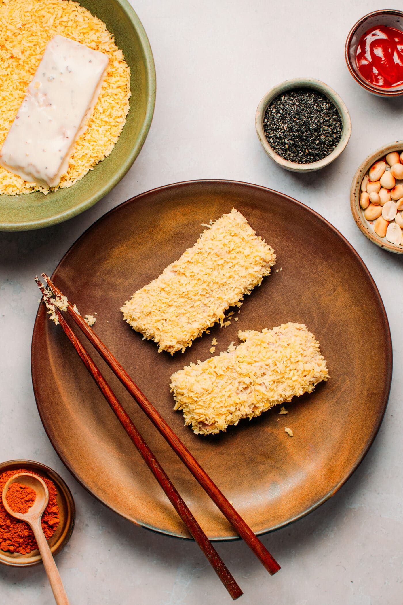 Dipping tempeh in panko breadcrumbs.