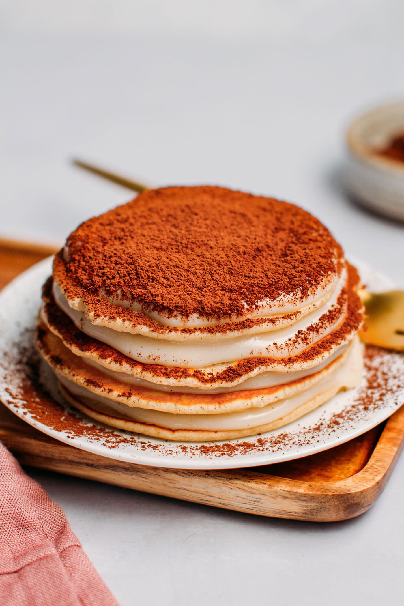 Tiramisu pancakes sprinkled with cacao powder.