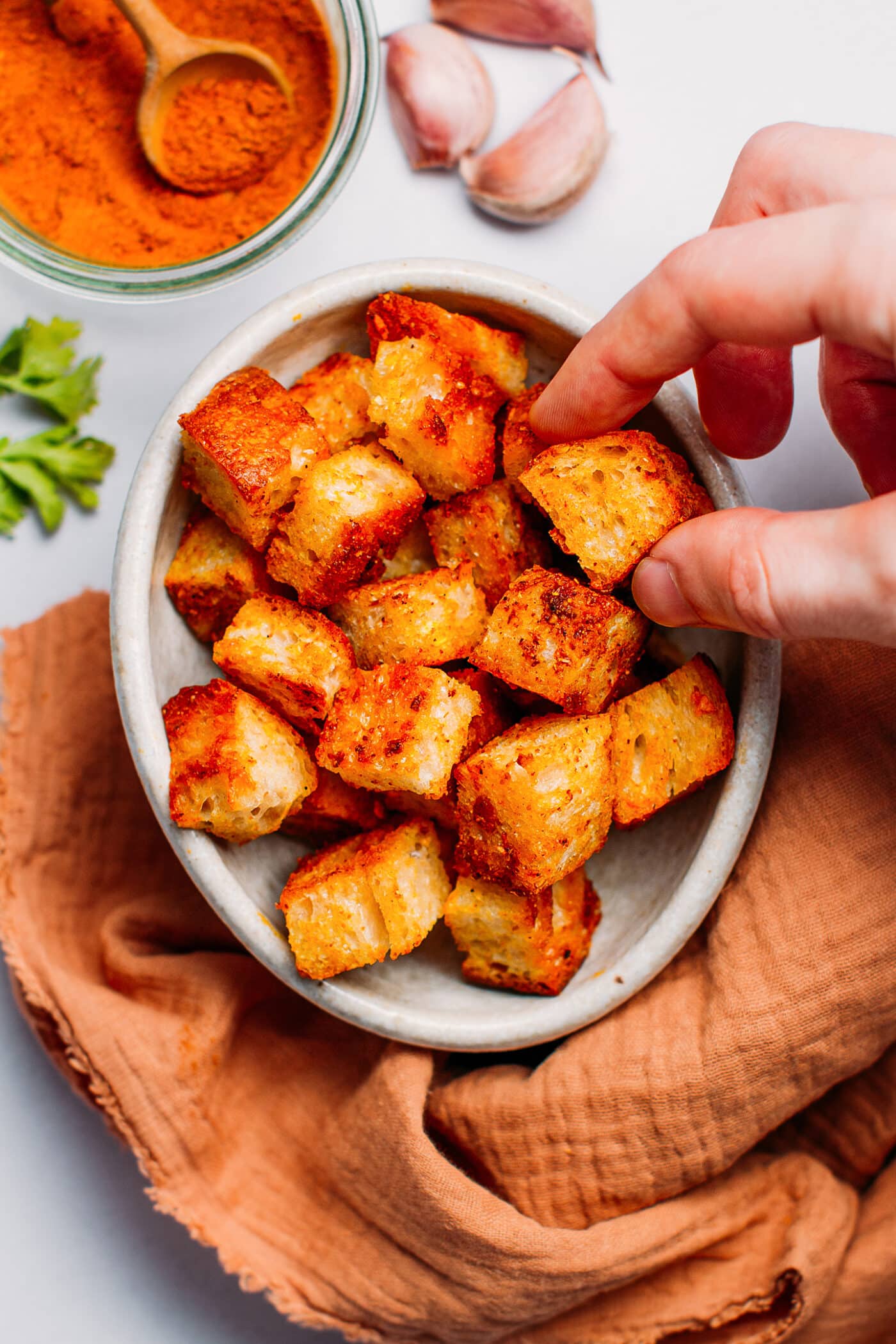 Picking a crouton out of a bowl.