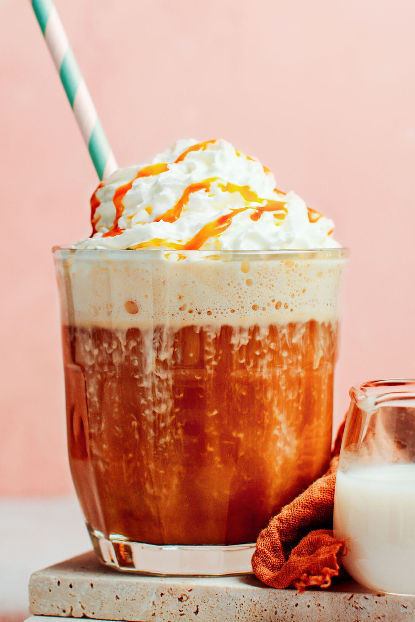 Caramel latte topped with whipping cream and caramel sauce.