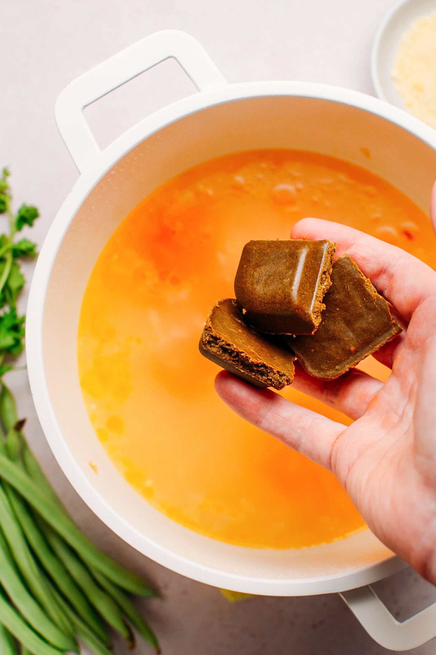 Adding Japanese curry cubes to a pot.