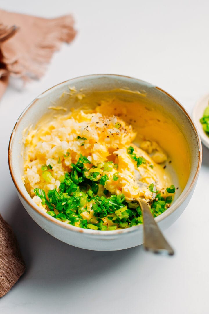 Butter, garlic, and green onions in a small bowl.