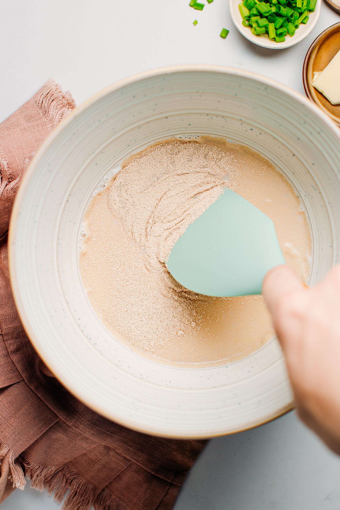 Dissolving yeast in warm milk.