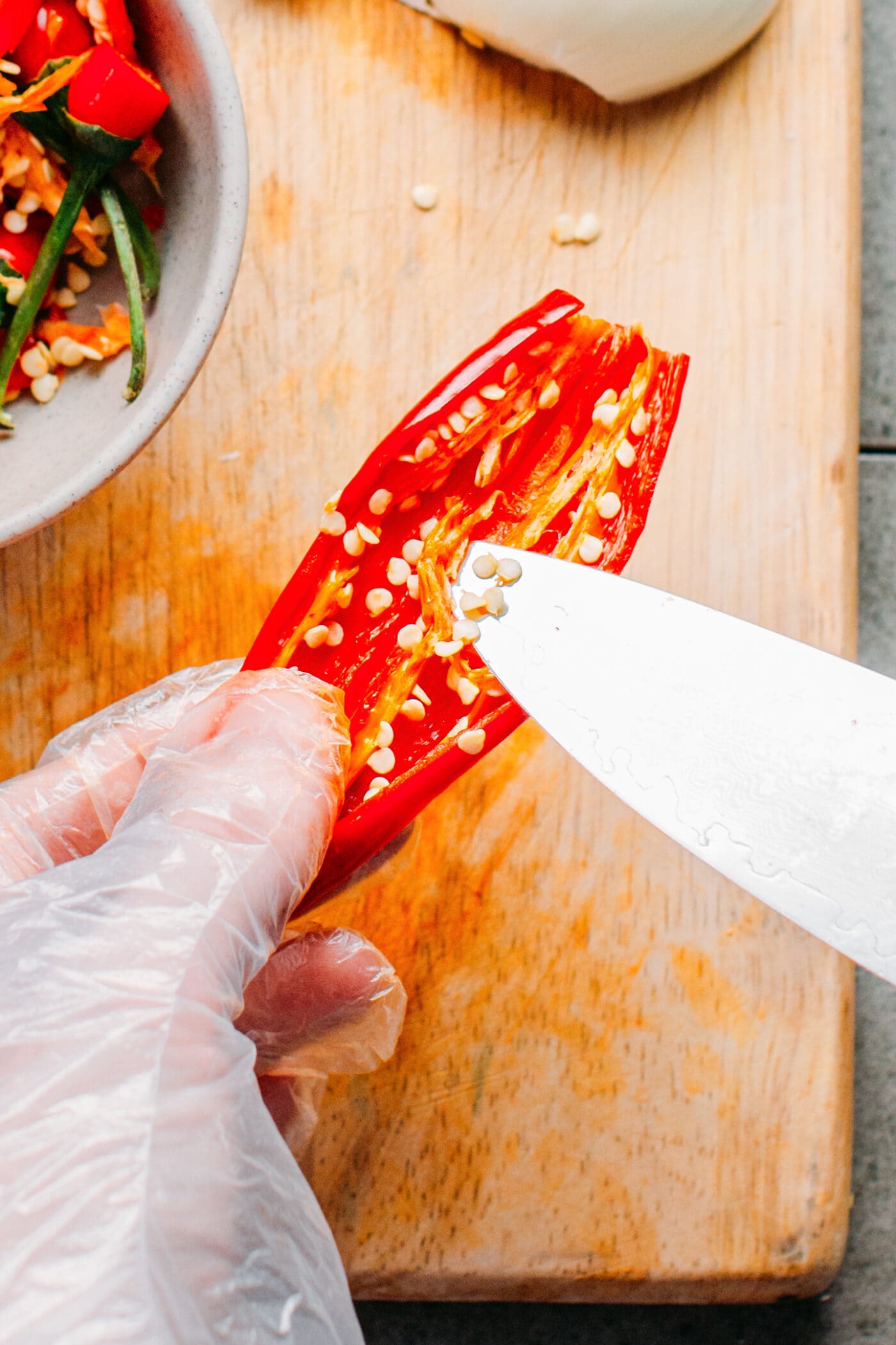 Removing seeds from a chili pepper.