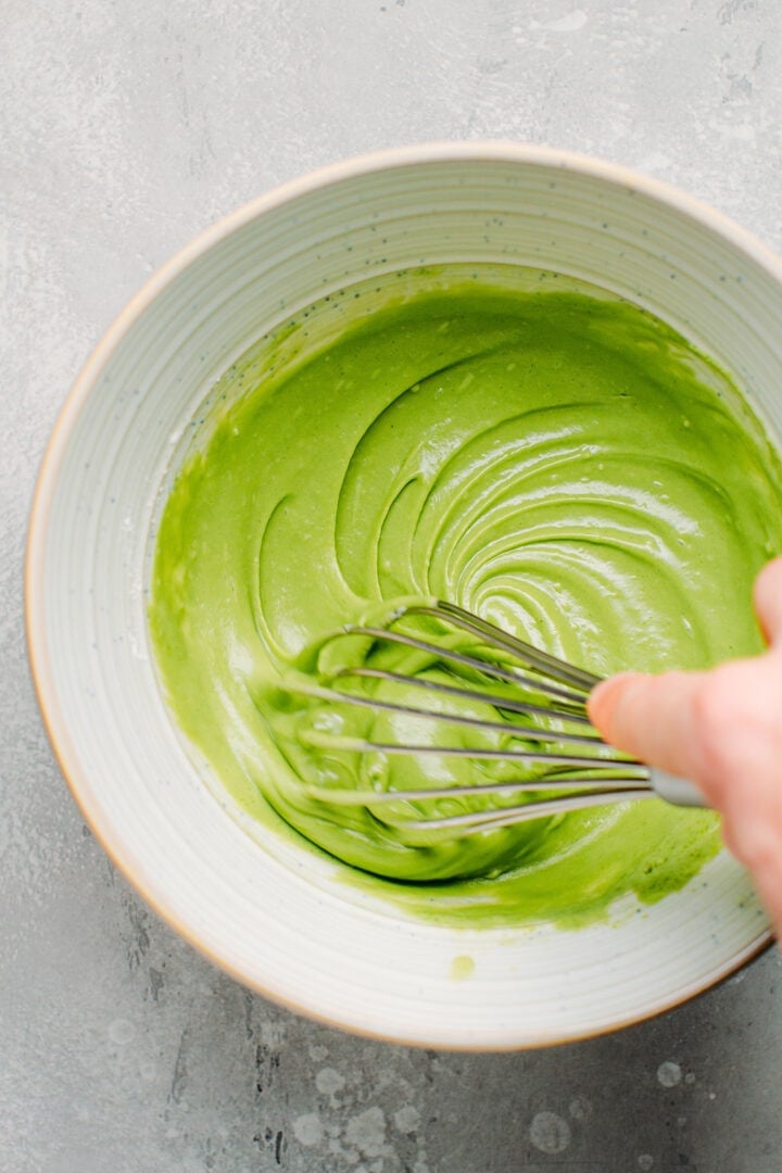 Whisking the batter to make matcha sponge cake.