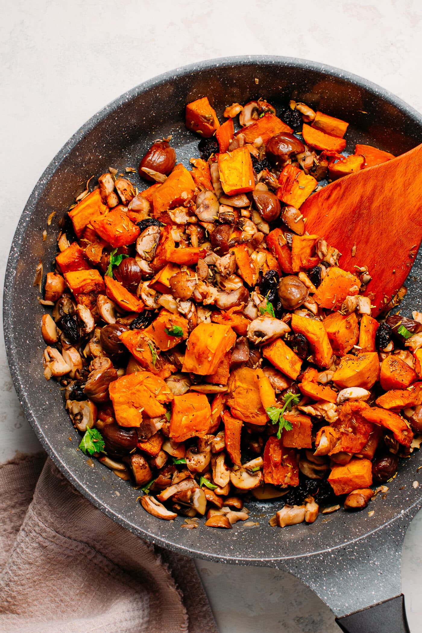 Roasted butternut squash, mushrooms, chestnuts, and herbs in a skillet to make Wellington.