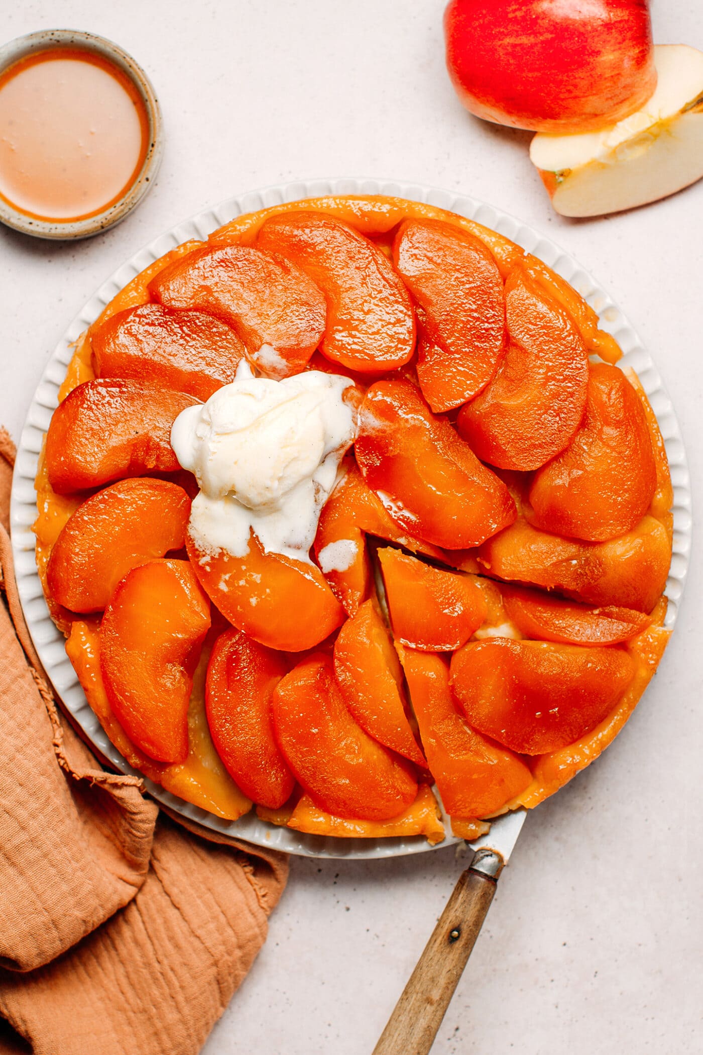 Apple tarte tatin topped with a scoop of vanilla ice cream.