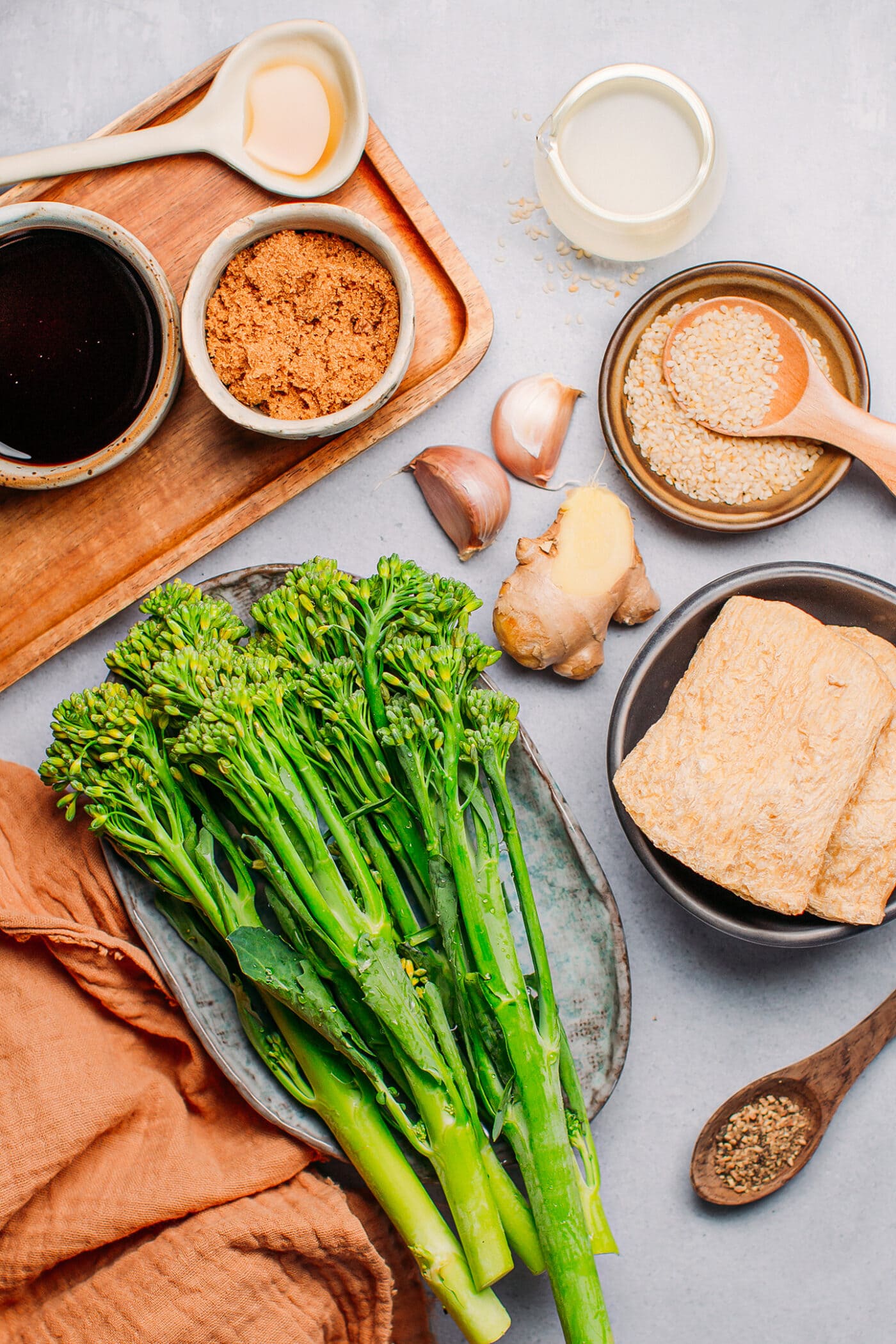 Ingredients like broccoli, TVP, ginger, garlic, sesame seeds, and soy sauce.