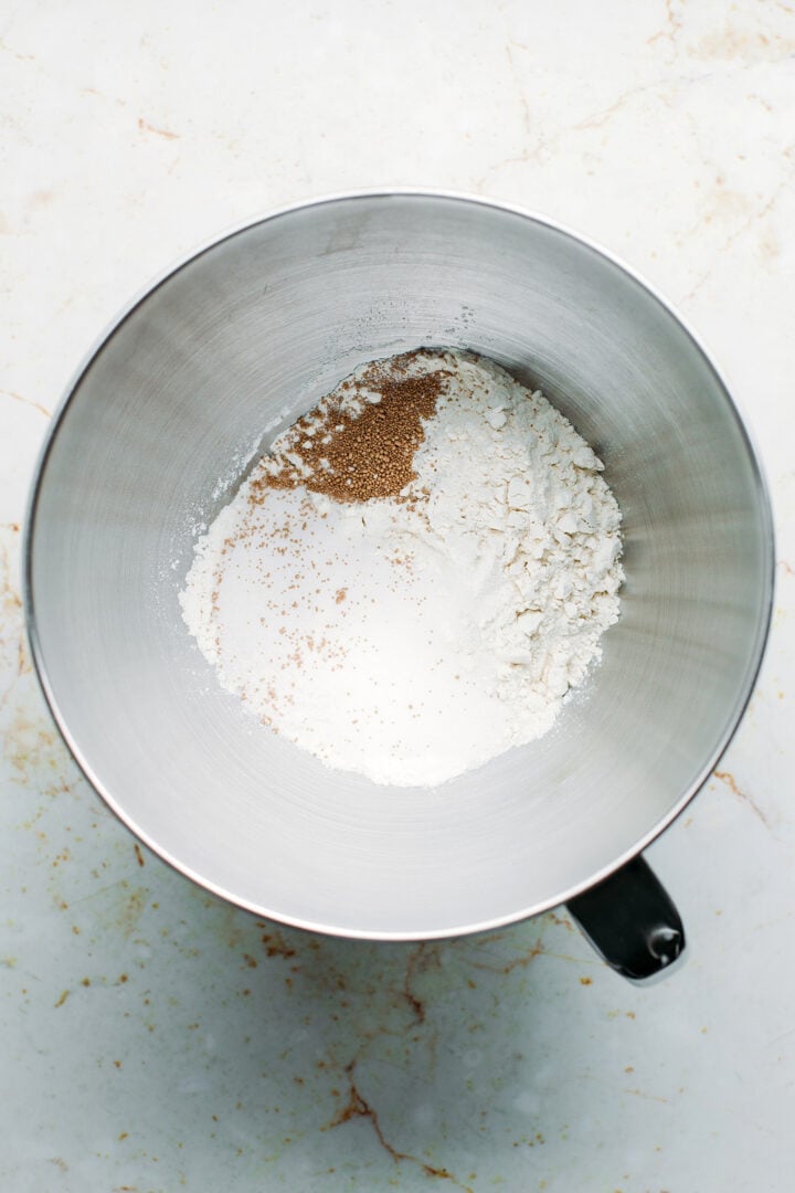 Flour, yeast, and sugar in a bowl.