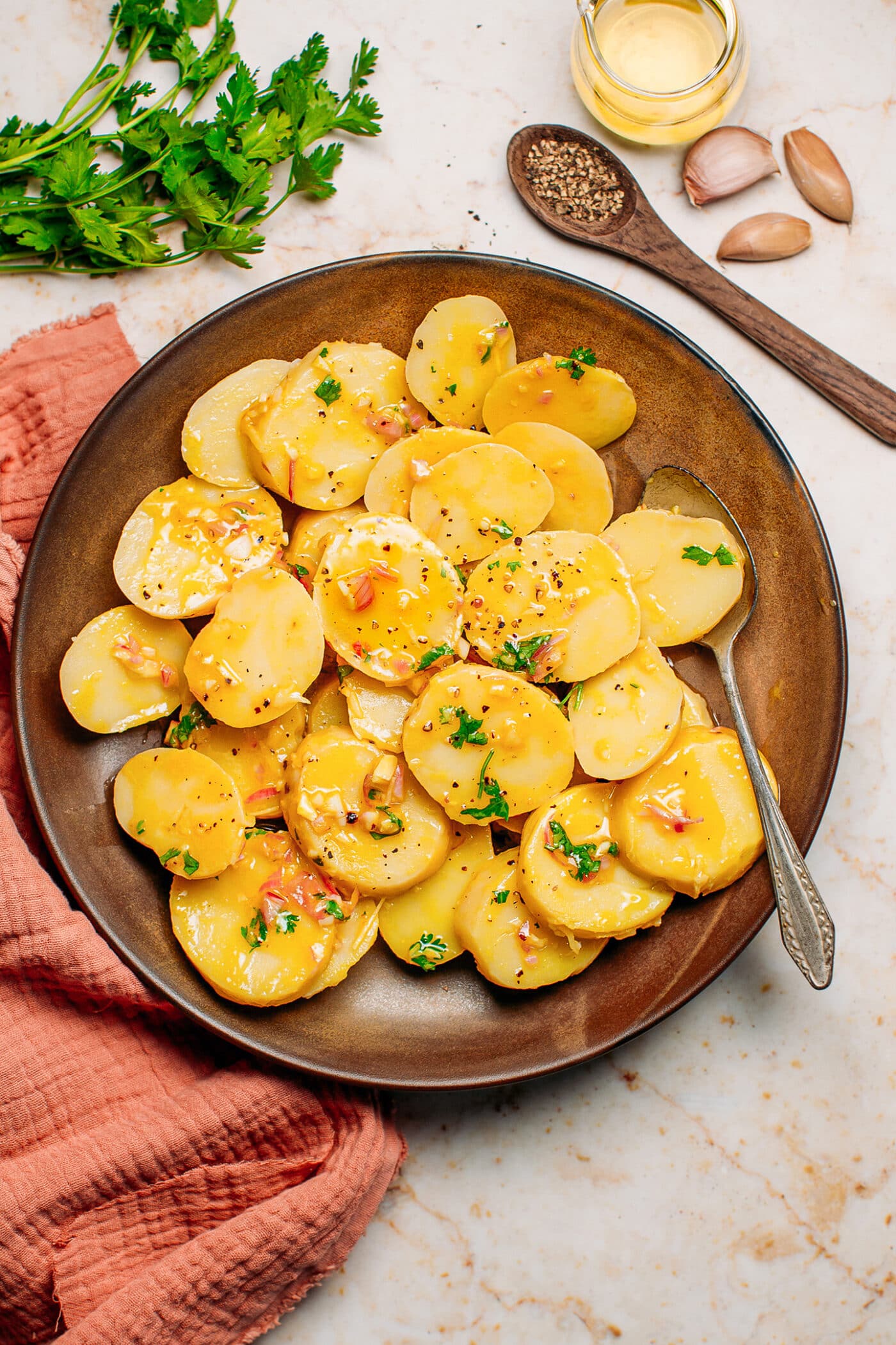 Vegan potato salad with vinaigrette, shallots, and garlic.