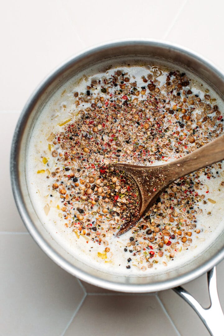 Crushed peppercorn sauce in a saucepan.