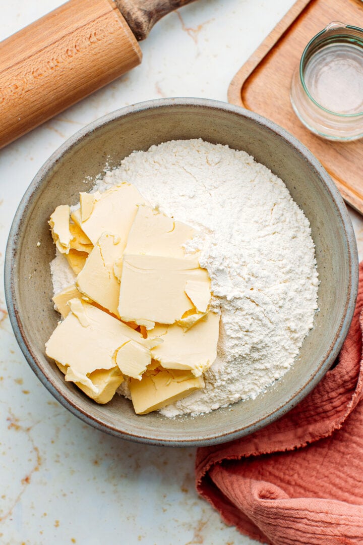 Flour and cold butter in a bowl.