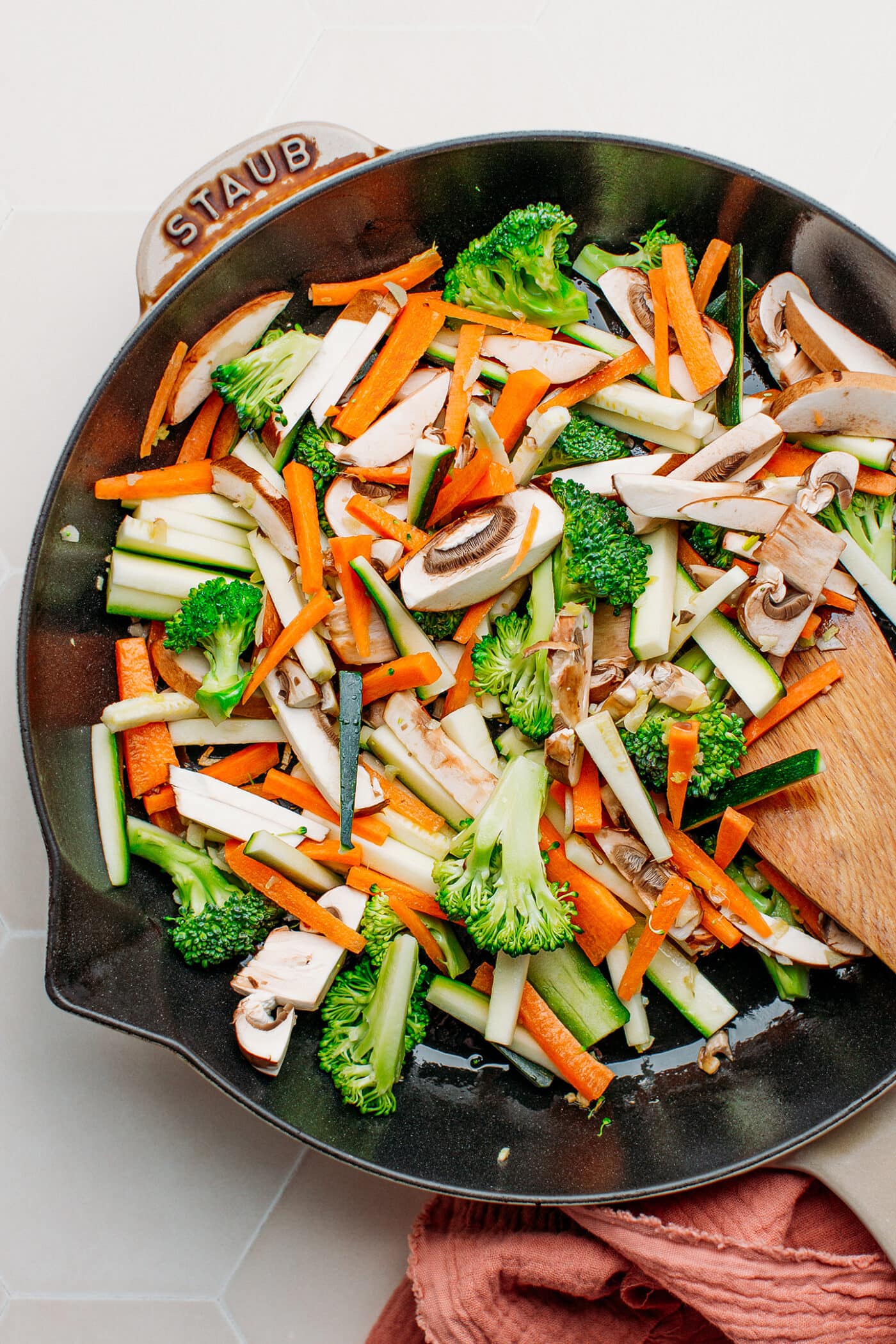 Raw vegetables in a skillet.