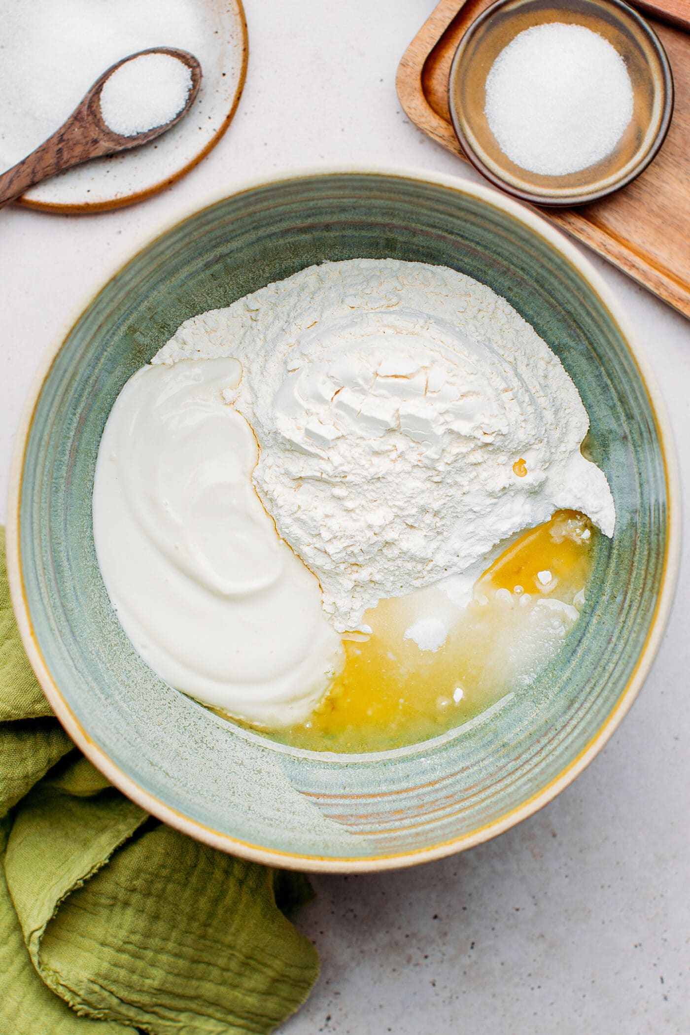 Flour, yogurt, oil, salt, and sugar in a mixing bowl.