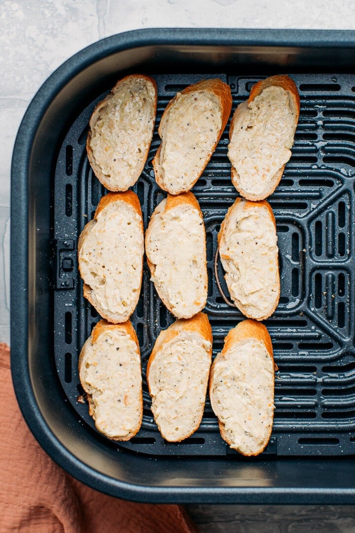 Garlic bread slices in an air fryer.