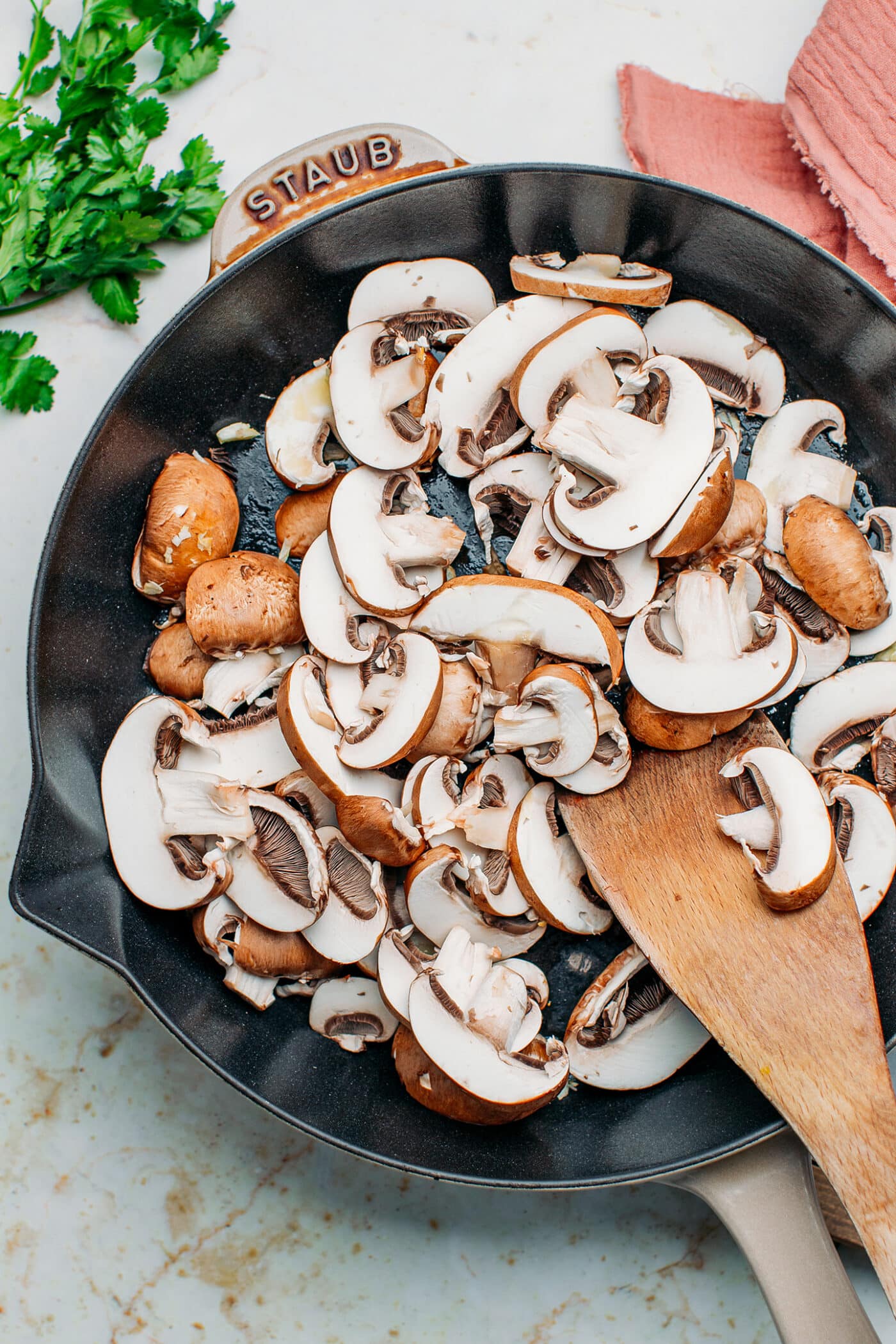 Sliced mushrooms in a skillet.