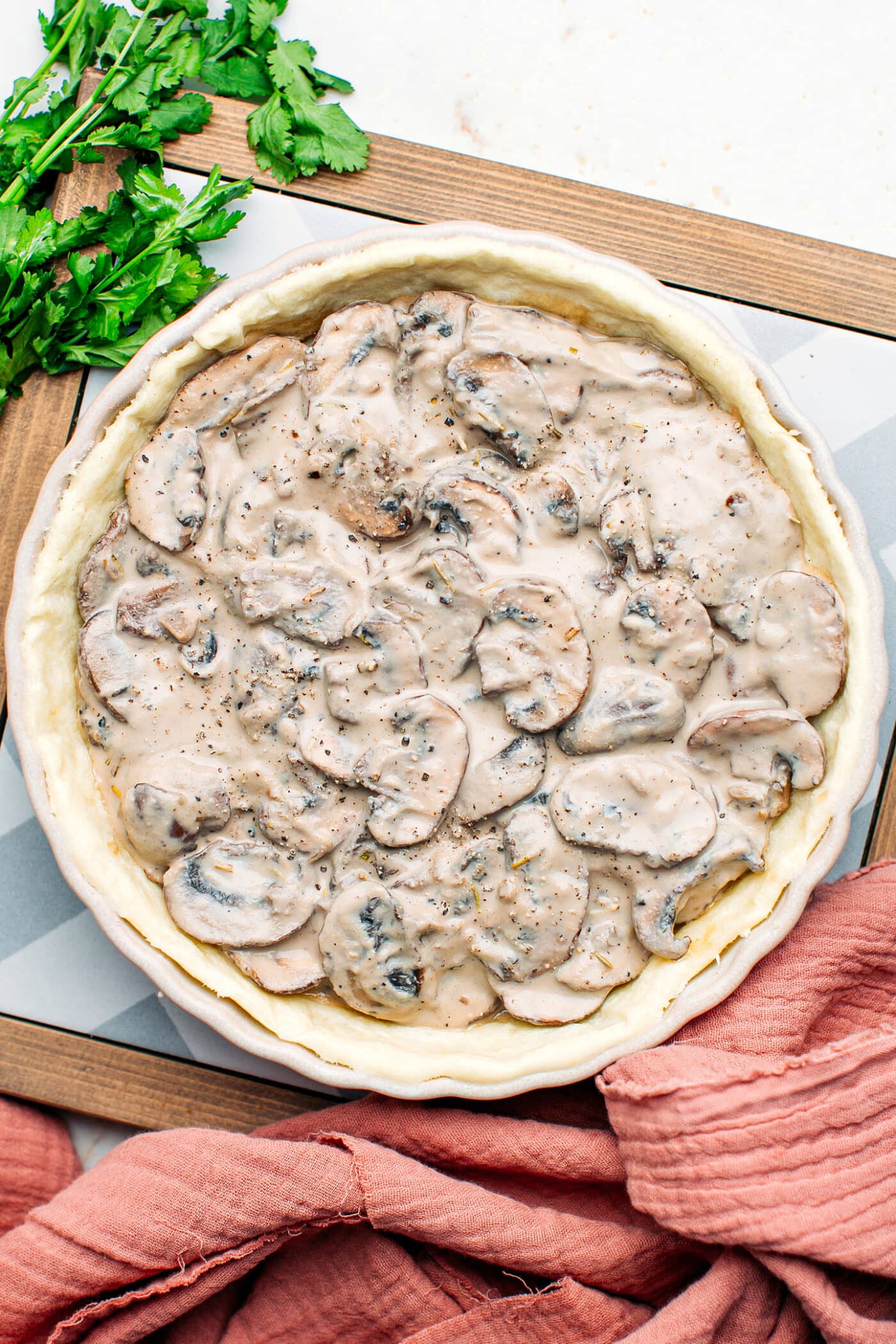 Unbaked mushroom tart in a pan.